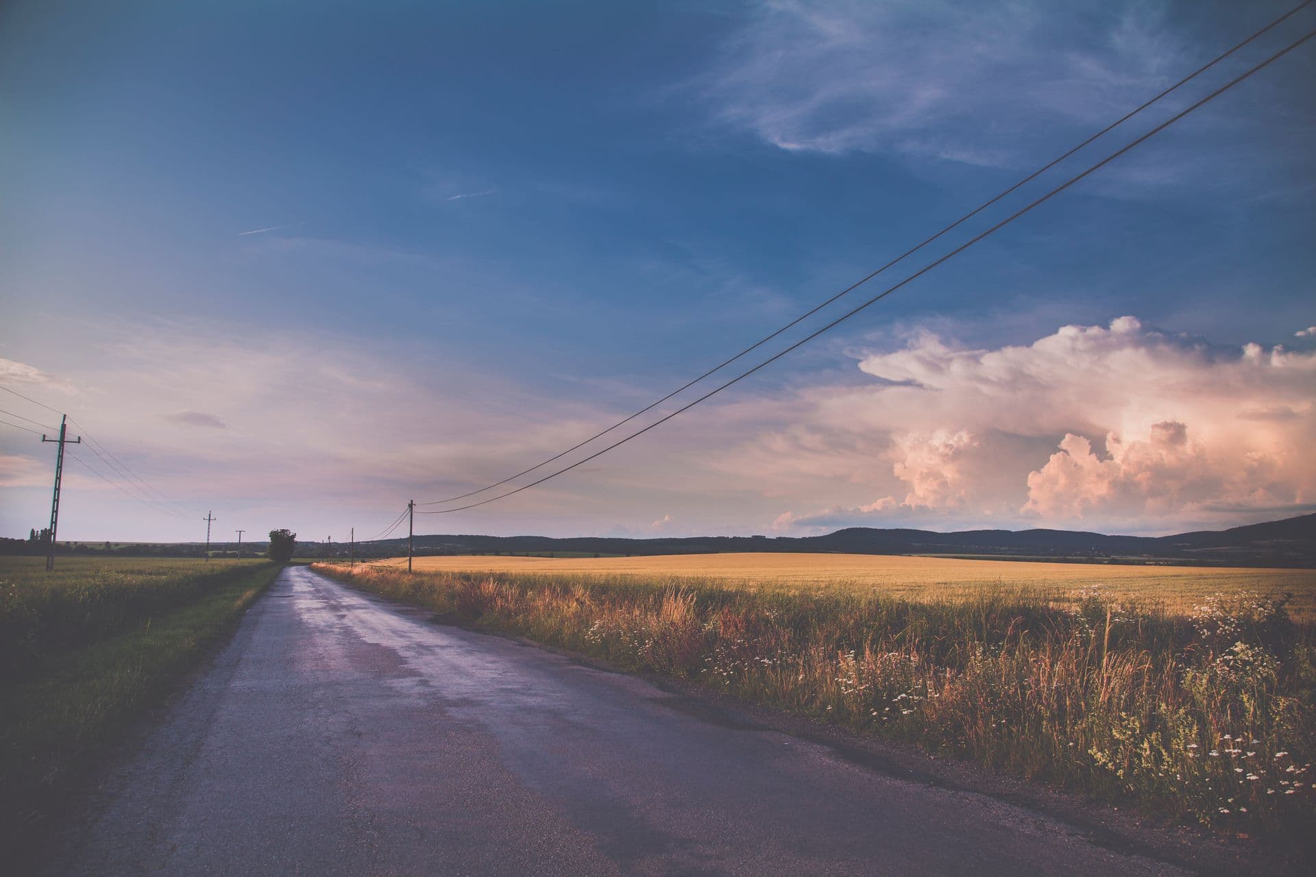 Empty rural two-lane road at dusk